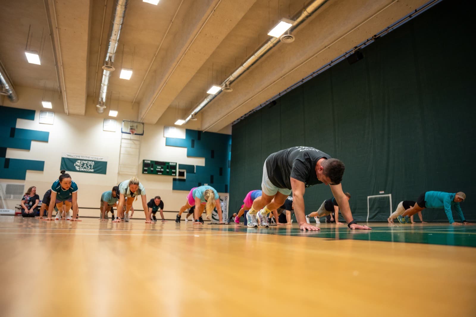 A group of people energetically engaged in a play-based workplace wellbeing session