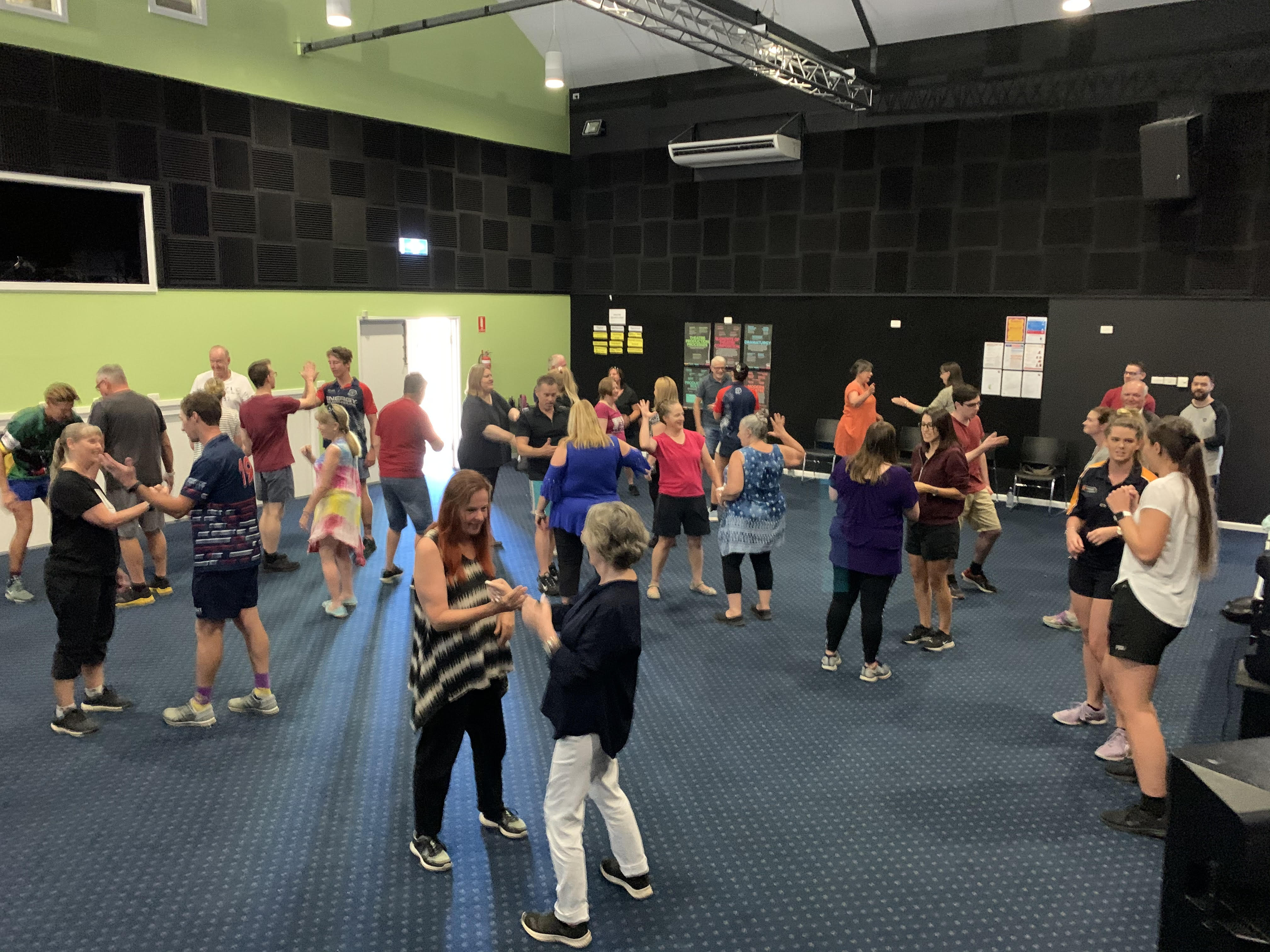 A large group of students laughing together during a play-based session