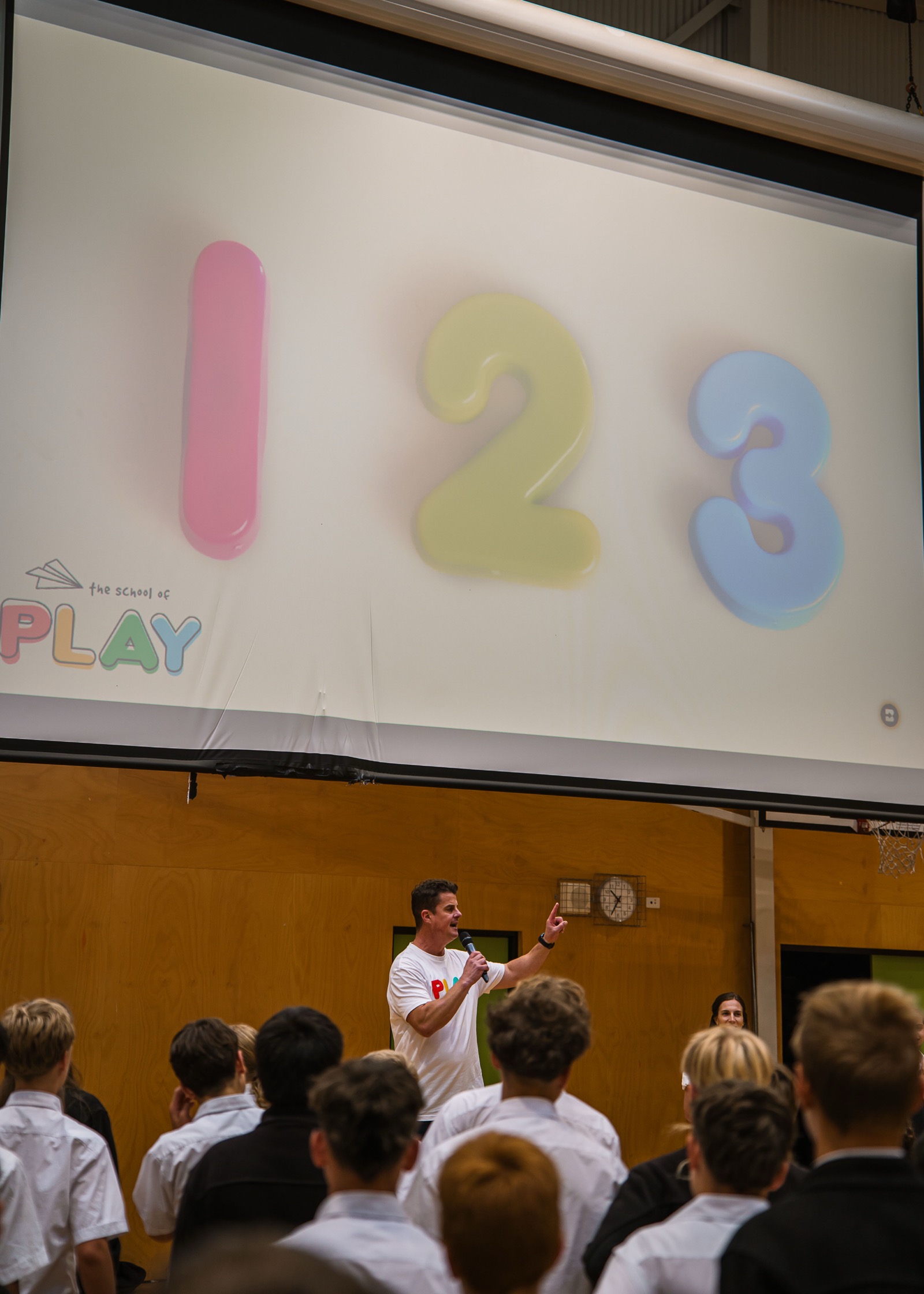 A teacher getting down to a child's level during a playful classroom moment